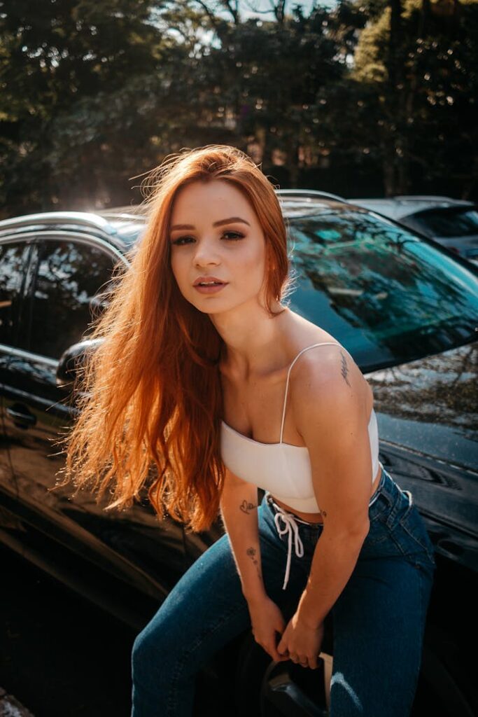 Photo Of Woman Sitting On Car